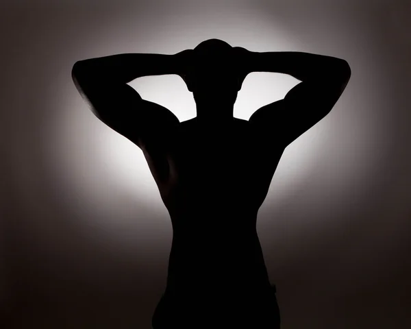 Silhouetted shirtless man — Stock Photo, Image
