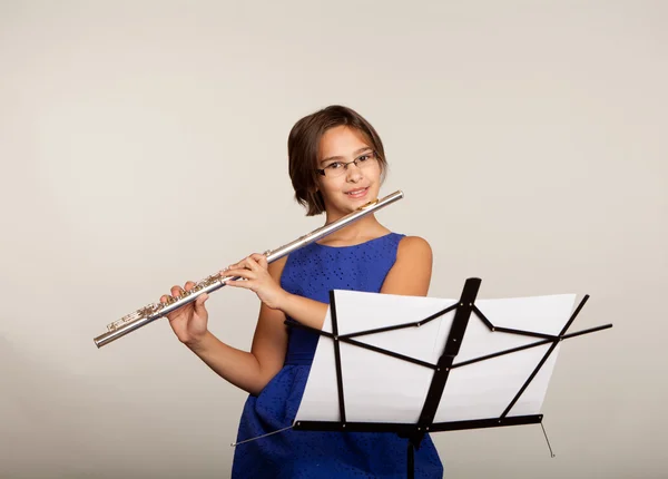 Menina tocando sua flauta em um vestido azul fantasia — Fotografia de Stock