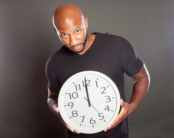 Man holding a clock — Stock Photo, Image