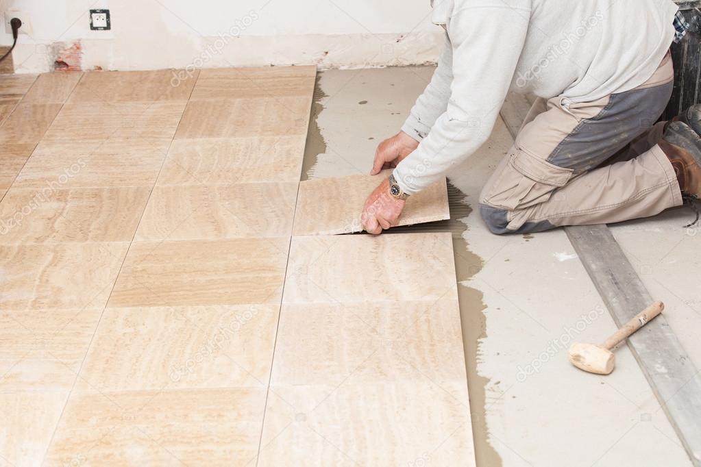 a tiler laying a tiled marble