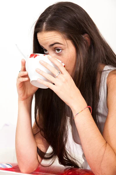 Woman drinking bowl at breakfast — Stock Photo, Image