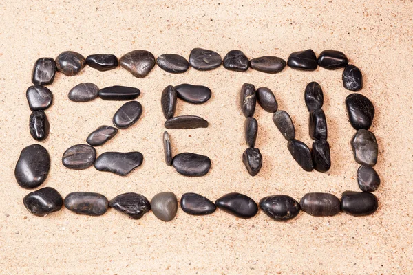 Zen word written with pebbles on the sand of a beach — Stock Photo, Image