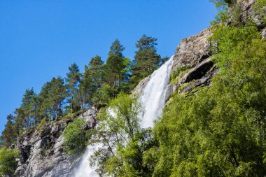 View of Tvindefossen or Tvinnefossen waterfall near Voss in Norway