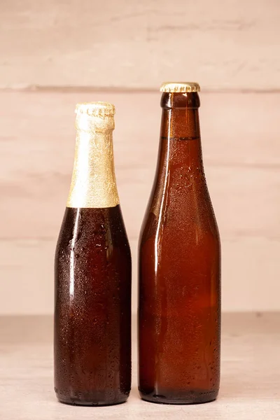 a bottle of blond beer and a bottle of amber beer