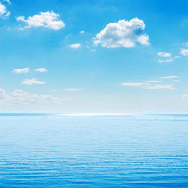 blue sea and cloudy sky over it clipart