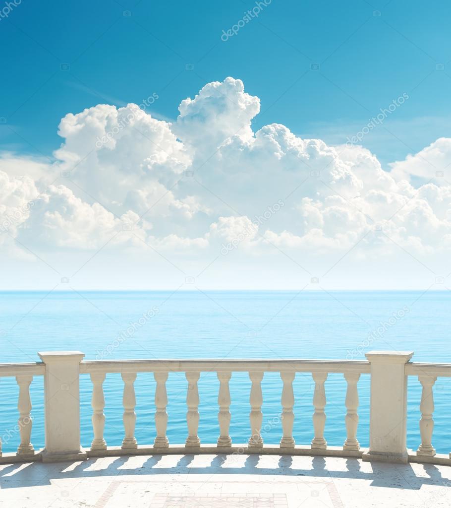 balcony near sea and clouds over it