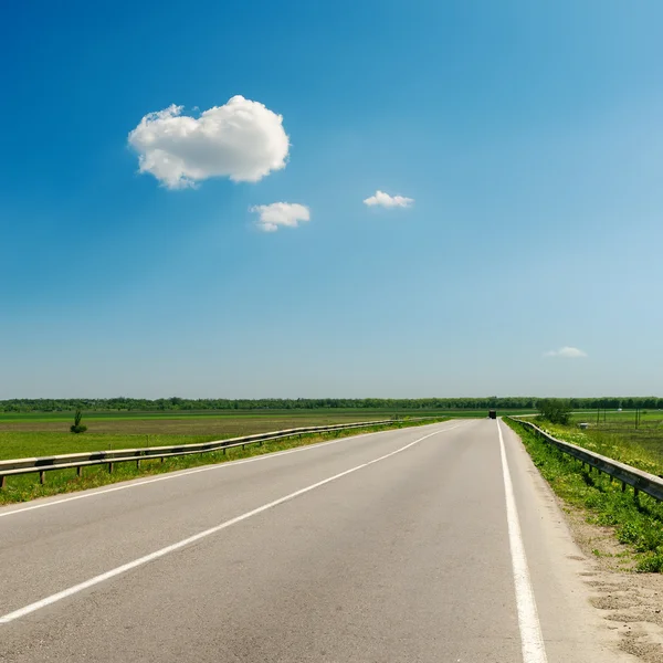 Estrada de asfalto ao horizonte sob o céu azul — Fotografia de Stock