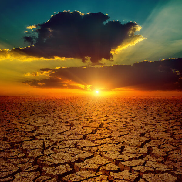 dramatic sunset over drought earth