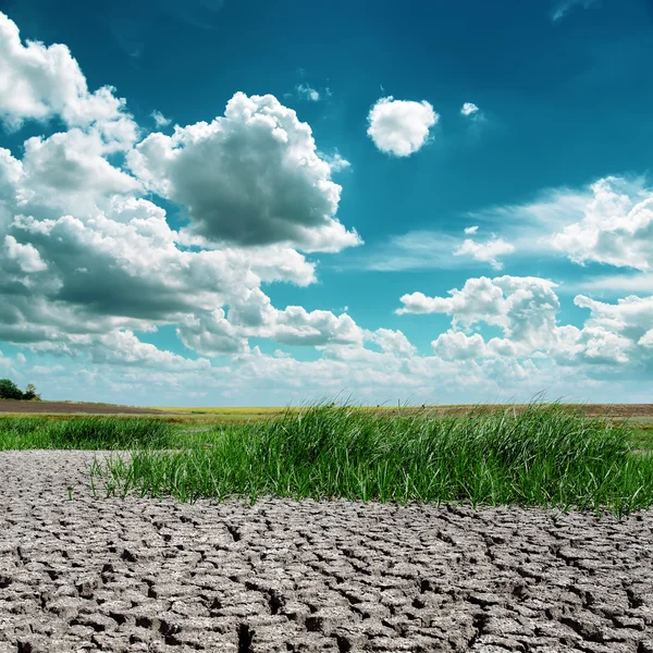 Dramatic sky over drought earth — Stock Photo, Image