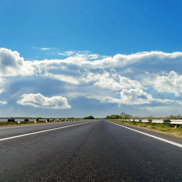 Bulutlu ufuk asfalt yol — Stok fotoğraf