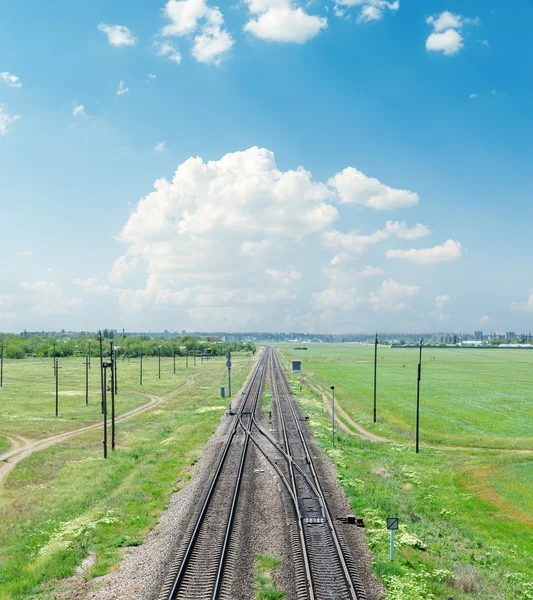 Railroad in green landscape under clouds — Stock Photo, Image