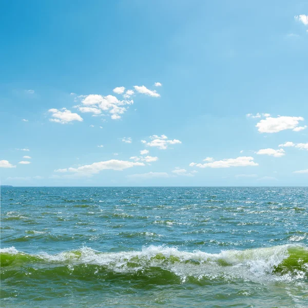 Голубое небо над морем с волнами — стоковое фото