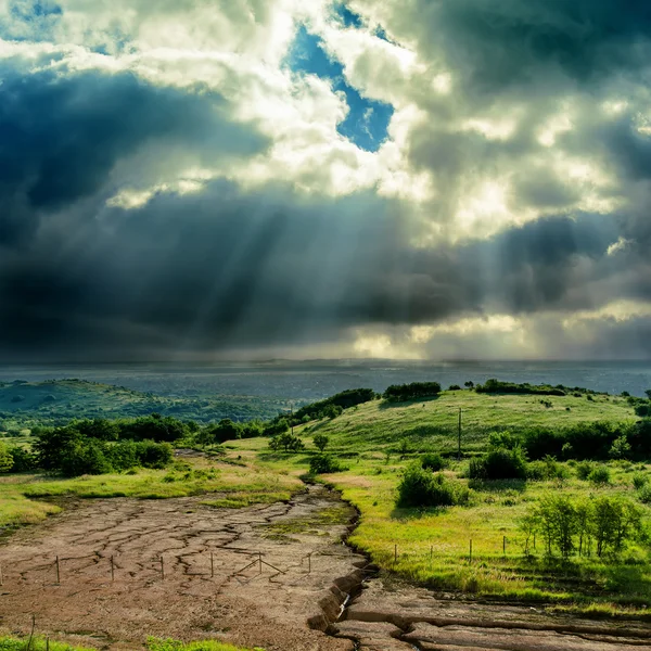 Cielo drammatico scuro sopra la montagna con erosione — Foto Stock