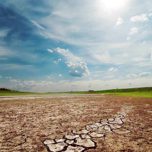 Cloudy sky over drought land — Stock Photo, Image