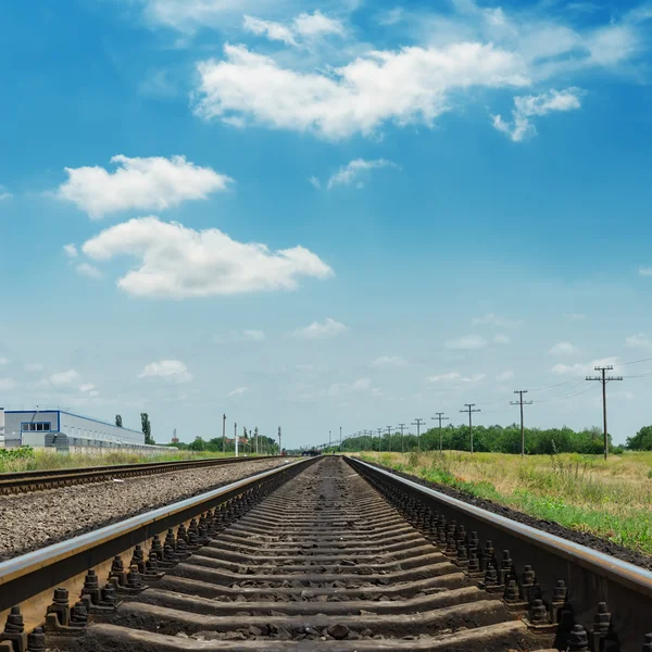 Railroad closeup and clouds in blue sky — Stock Photo, Image