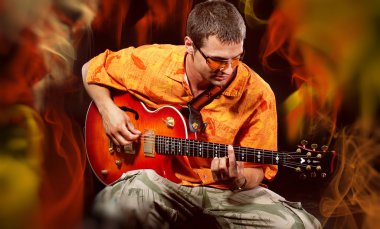 Musician Man playing electronic guitar at bright background