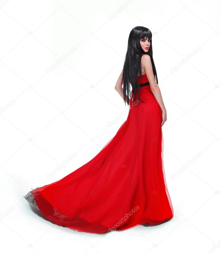 Elegant brunette girl posing in red gorgeous dress isolated on w