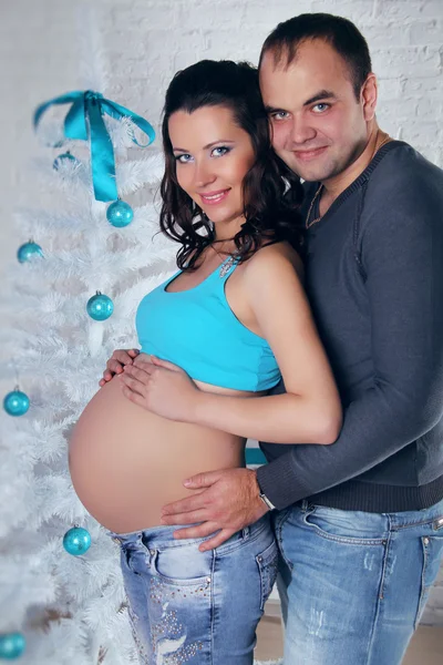 Loving couple family embracing with pregnant belly and Christmas — Stock Photo, Image