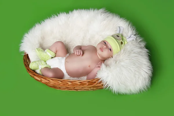 Lying newborn baby on green background — Stock Photo, Image