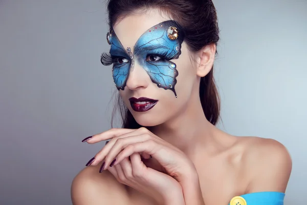 Mode makeup. Butterfly ansikte konst kvinna porträtt. — Stockfoto