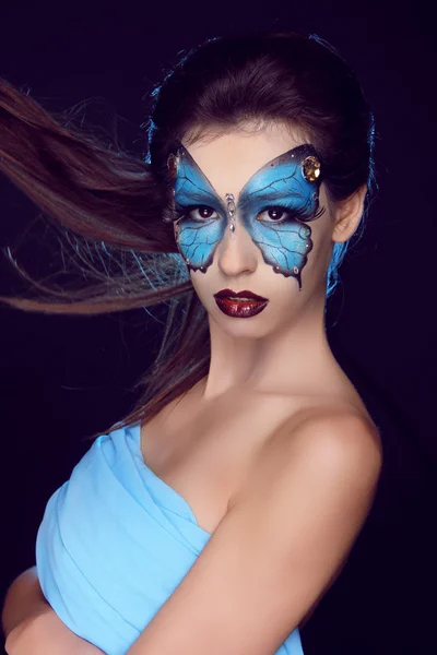 Fashion woman Portrait. Butterfly makeup, face art make up Stock Photo