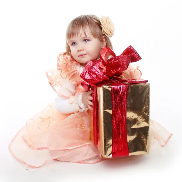 Little girl playing with gift box ribbon isolated on white backg — Stock Photo, Image