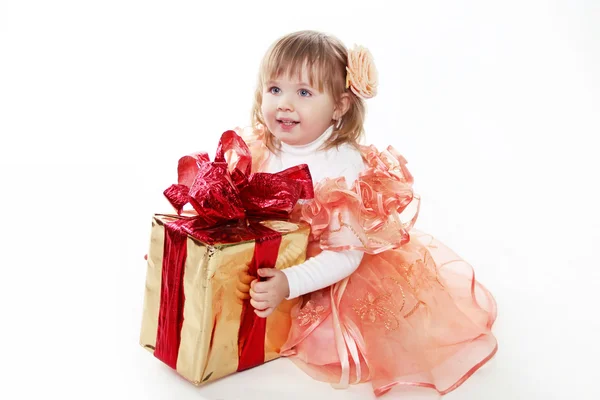 Little girl playing with gift box, red ribbon isolated on white — Stock Photo, Image