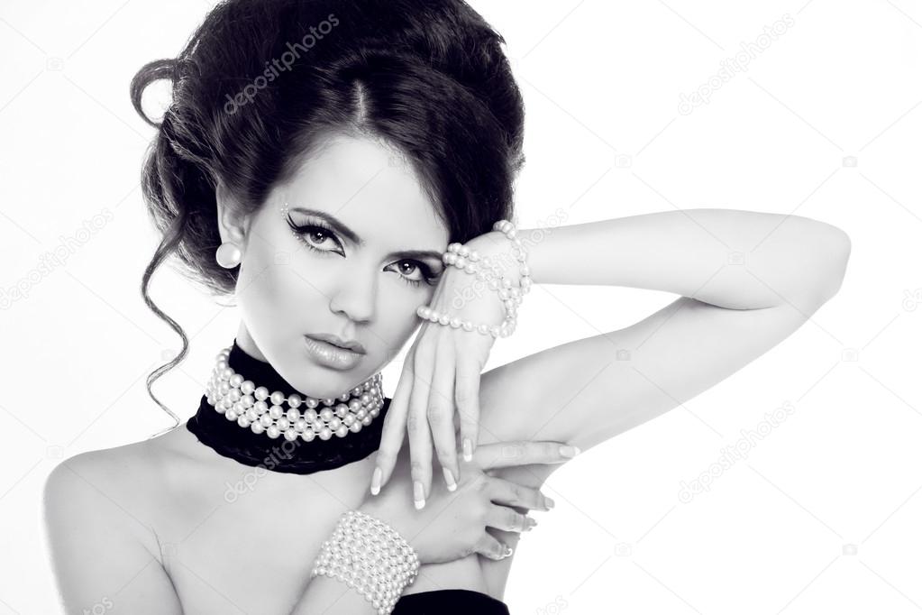 Fashion portrait of beautiful woman with pearls, black and white