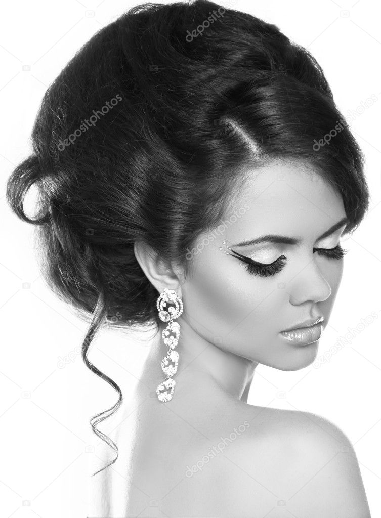 Beautiful woman with fashion hair and evening make-up. Jewelry a