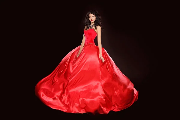 Beautiful woman wearing in magnificent red dress isolated on bla — Stock Photo, Image