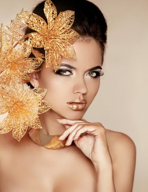 Beautiful Girl With Golden Flowers. Beauty Model Woman Face. Per