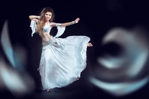 Beautiful exotic belly dancer woman running on the waves. isolat — Stock Photo, Image