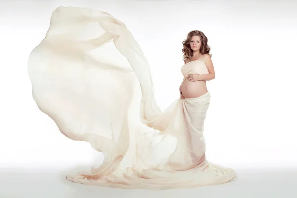 Hermosa joven embarazada acariciando su vientre con soplado w —  Fotos de Stock