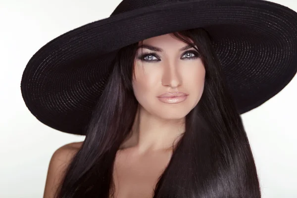 Fashion brunette woman model posing in black hat isolated on whi — Stock Photo, Image