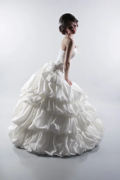 Glamorous bride woman in magnificent wedding dress isolated on g — Stock Photo, Image