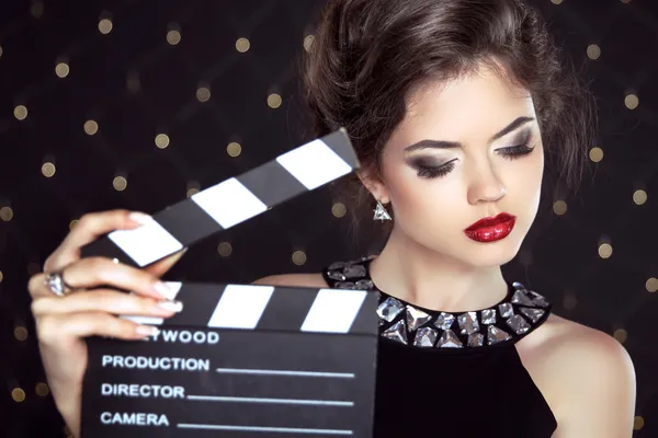 Fashion woman with sexy red lips holding cinema clap. Super star — Stock Photo, Image