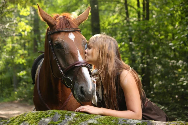 Beautiful girl and brown horse portrait in mysterious forest — Stock Photo, Image