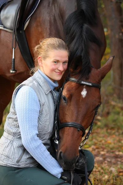 Beautiful blonde woman and brown horse — Stock Photo, Image