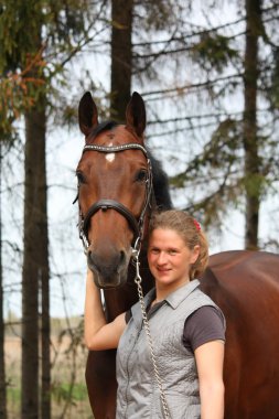 Genç sarışın kadın ve defne at birlikte