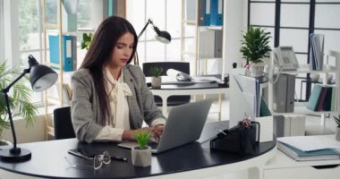 Ofisteki dizüstü bilgisayarda çalışan genç iş kadını