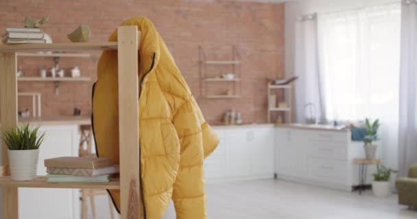 Puffer Jacket Hanging Shelf Unit Studio Apartment Young Woman Video — Stock Video