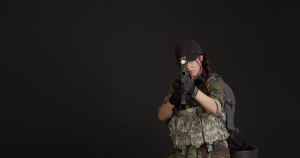 Young Female Soldier Aiming Viewer Black Background — Stock Video