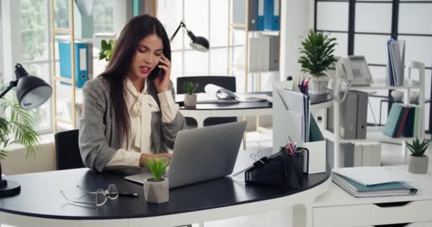 Młoda Bizneswoman Rozmawia Przez Telefon Podczas Pracy Laptopie Biurze — Wideo stockowe