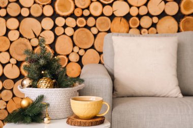 Bir fincan çay ve Noel dekoru masanın üstünde.