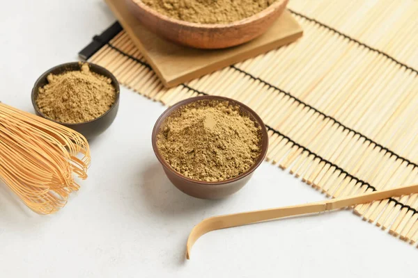 Beyaz arka planda hojicha pudrası olan kaseler