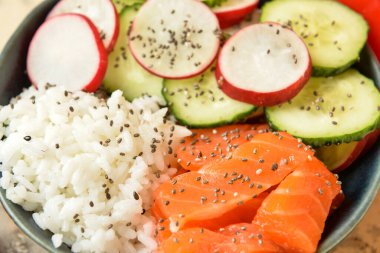 Somon ve sebzeli lezzetli bir kase, yakın plan.