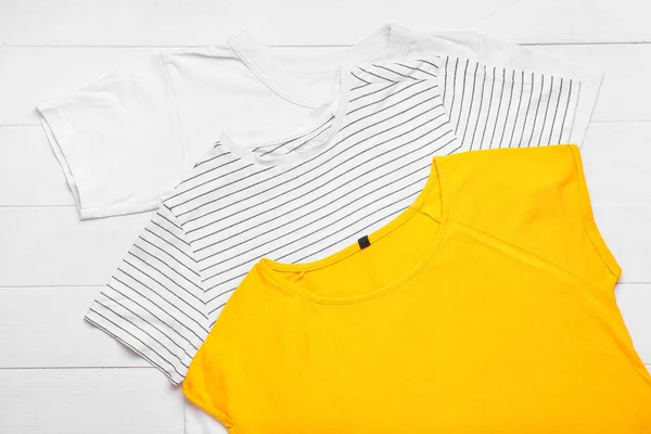 Verschillende Shirts Witte Houten Achtergrond Close — Stockfoto