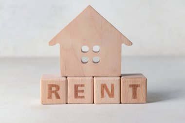 Beyaz arka planda kelime RENT ile ahşap ev