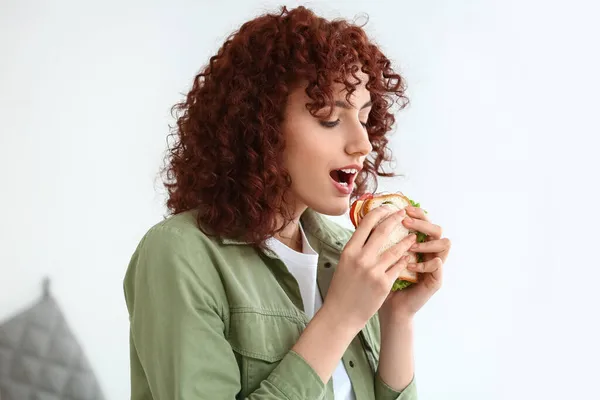 Красивая Девушка Ест Вкусный Сэндвич Кухне — стоковое фото