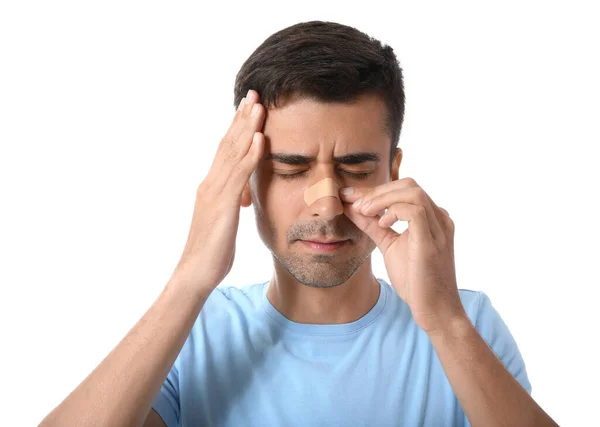 Young Man Applying Plaster His Nose White Background — Stock Photo, Image